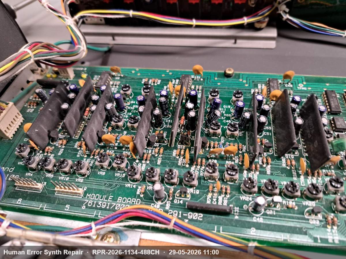 Groene module board PCB 291-902 van de Juno-106 met zes zwarte voice-chip modules en diverse elektrolytische condensatoren.